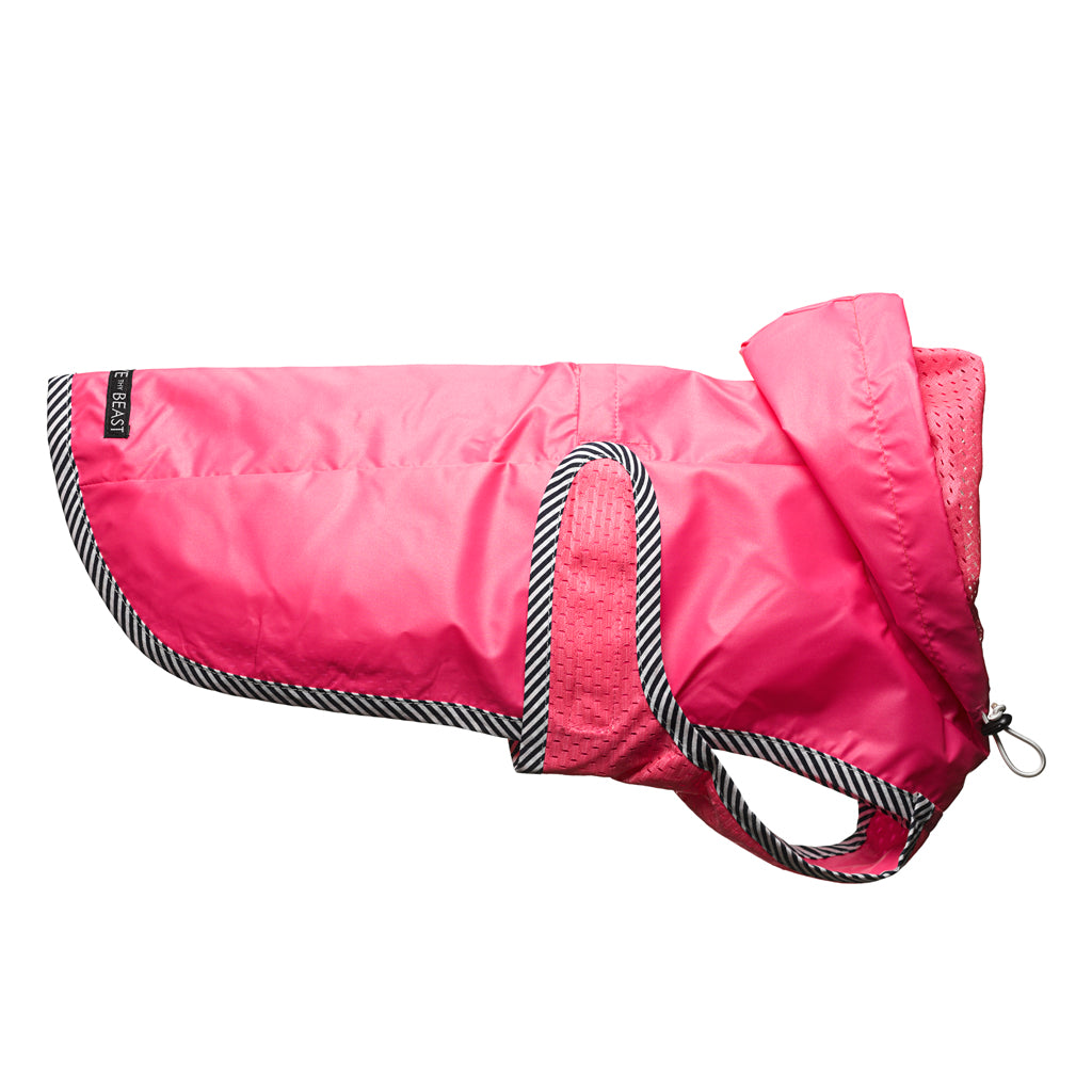 usa made sleek water repellent nylon dog jacket in neon pink with pink lining and striped trim with harness hole 