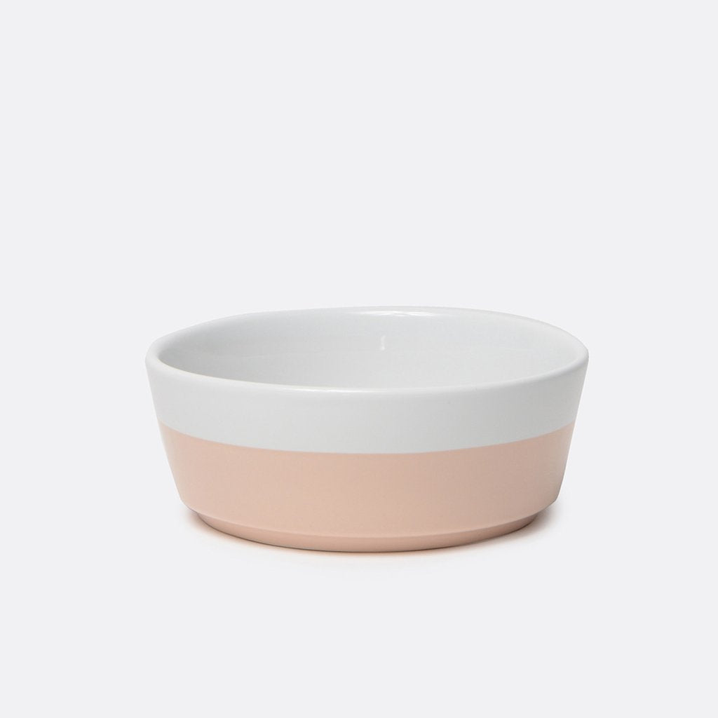 modern white weighted ceramic pet bowl with blush hand dipped bottom 