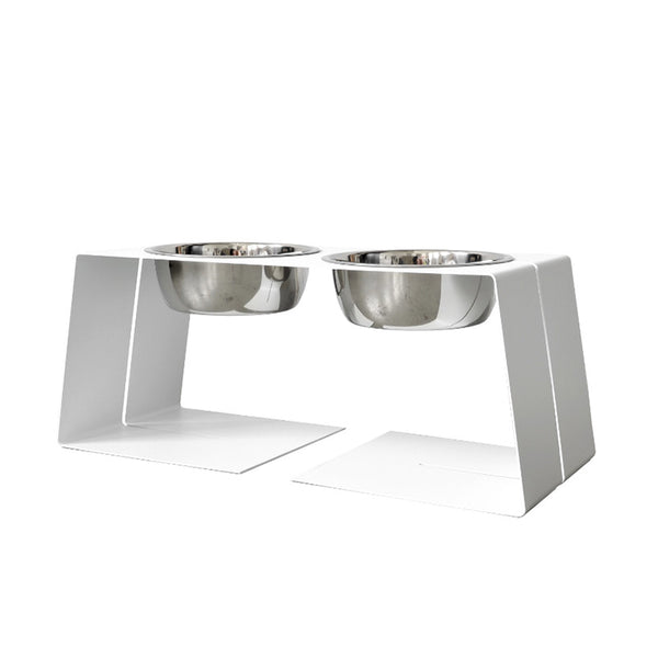 modern designer elevated pet food stand in white with two stainless steel bowls and silicone bumpers 